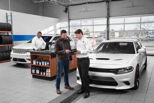 Boone Chrysler Dodge Jeep Ram in Boone NC image of customer working with a sales rep